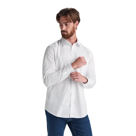 Man wearing a white shirt and blue jeans on a light gray background