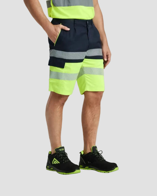 Person wearing high-visibility safety shorts with reflective stripes on a plain background