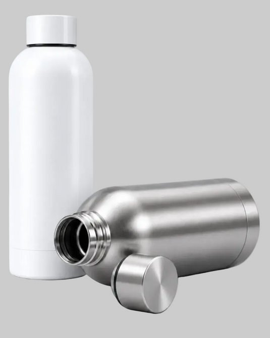 A matte white insulated bottle stands upright next to a stainless steel bottle shown open, with its cap placed in front, on a light gray background.