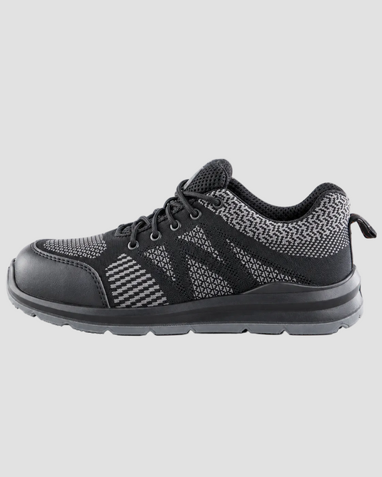 A black low-top sneaker with a textured knit upper, perforated side panels, black laces, and a chunky ribbed sole, shown in a side profile on a white background.