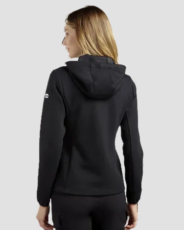 A woman shown from the back wearing a black hooded sweatshirt and matching black pants against a plain white studio background.
