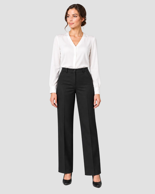 A woman modeling a white long-sleeve blouse tucked into black wide-leg trousers, standing against a light gray studio background.