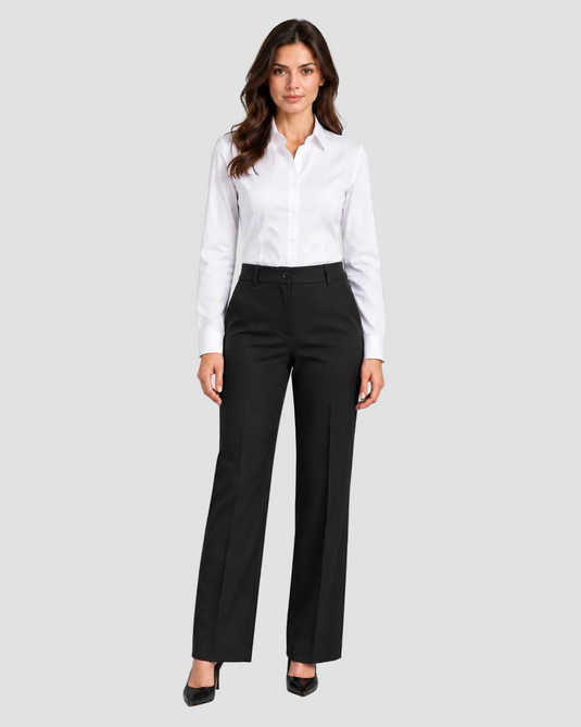 A woman modeling a white long-sleeve button-down shirt and black wide-leg trousers against a solid gray studio background.